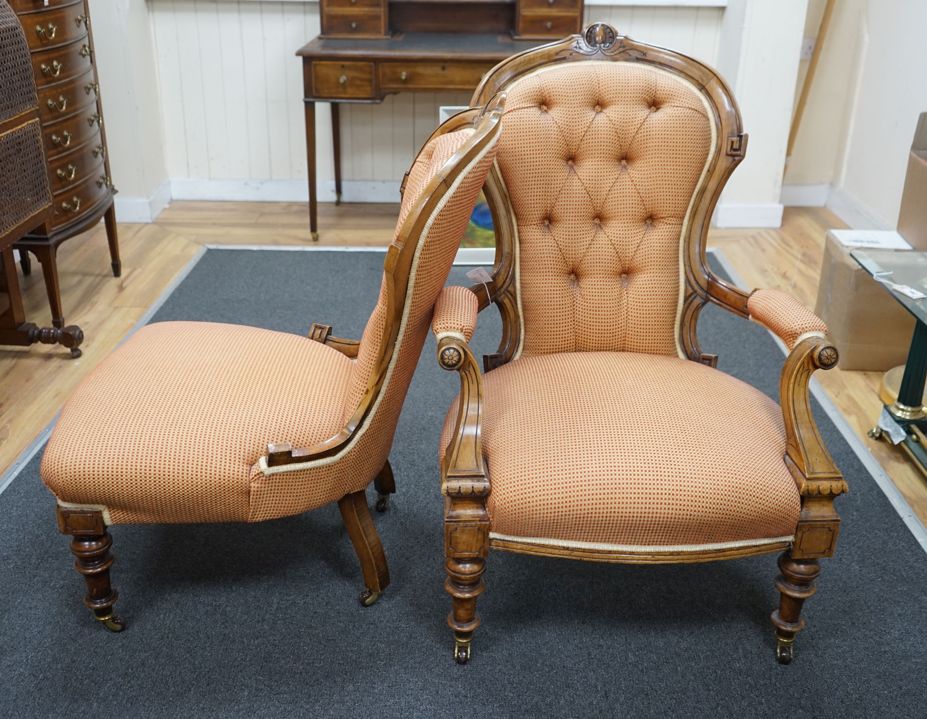 A pair of late Victorian walnut spoon back chairs, one with arms, larger width 68cm, depth 60cm, height 100cm